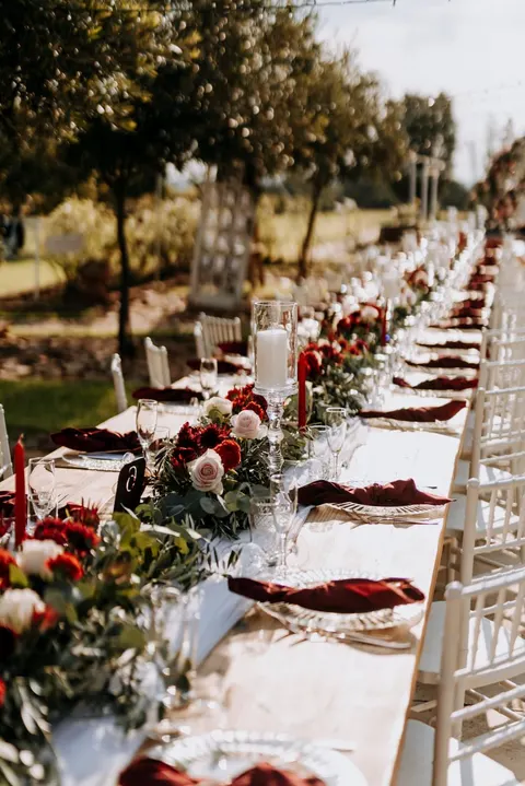 Reception tables in perspective at dusk, string lights overhead