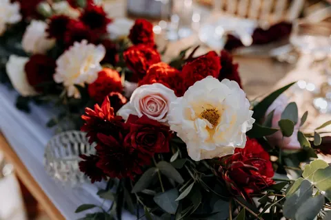 Close detail of a red and white rose and dahlia garland